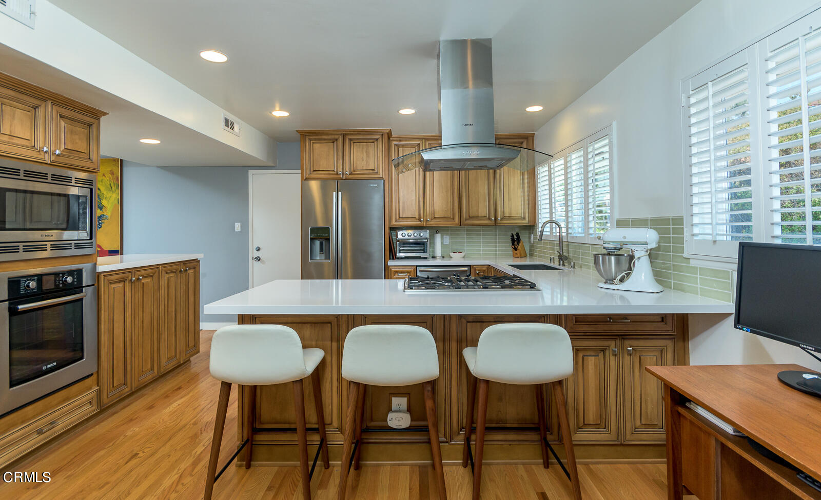 667 Glen Avenue Glendale, CA 91206 - Photo 13 of 46 a kitchen with stainless steel appliances granite countertop a table chairs stove refrigerator and cabinets
