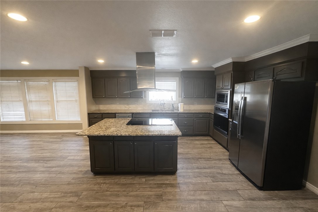 4005 Ridge Trail Robstown, TX 78380 - Photo 10 of 20 a kitchen with kitchen island a sink stainless steel appliances and counter space
