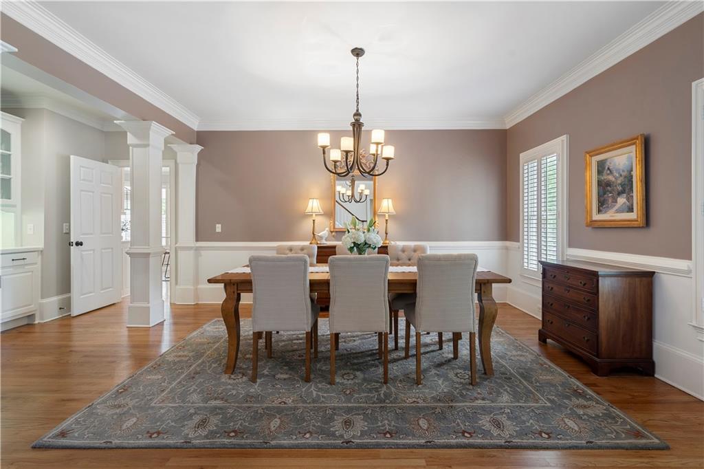 1174 Bowerie Chase Powder Springs, GA 30127 - Photo 13 of 70 a view of a dining room with furniture window and wooden floor