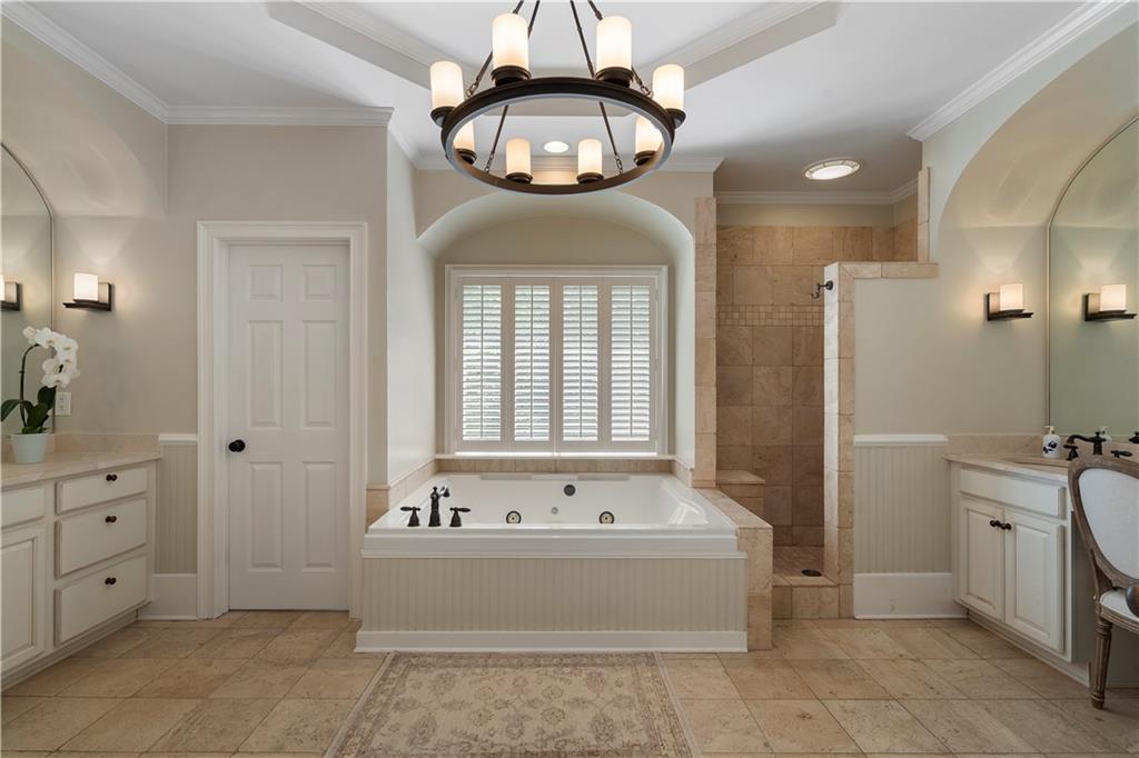 1174 Bowerie Chase Powder Springs, GA 30127 - Photo 26 of 70 a spacious bathroom with a tub sink and mirror