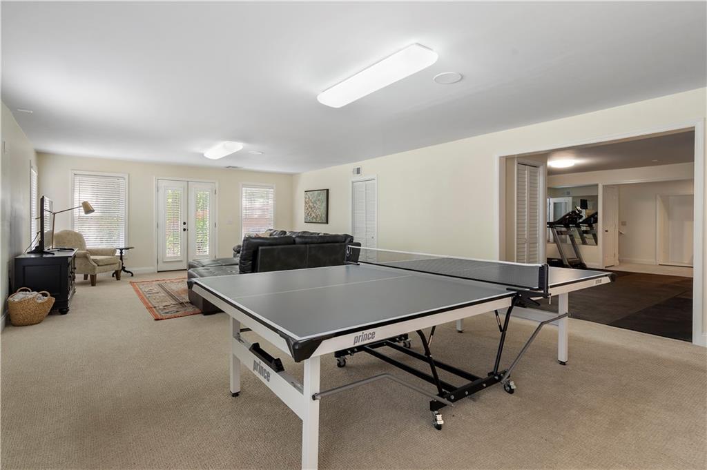 1174 Bowerie Chase Powder Springs, GA 30127 - Photo 51 of 70 a room with gym equipment and a table
