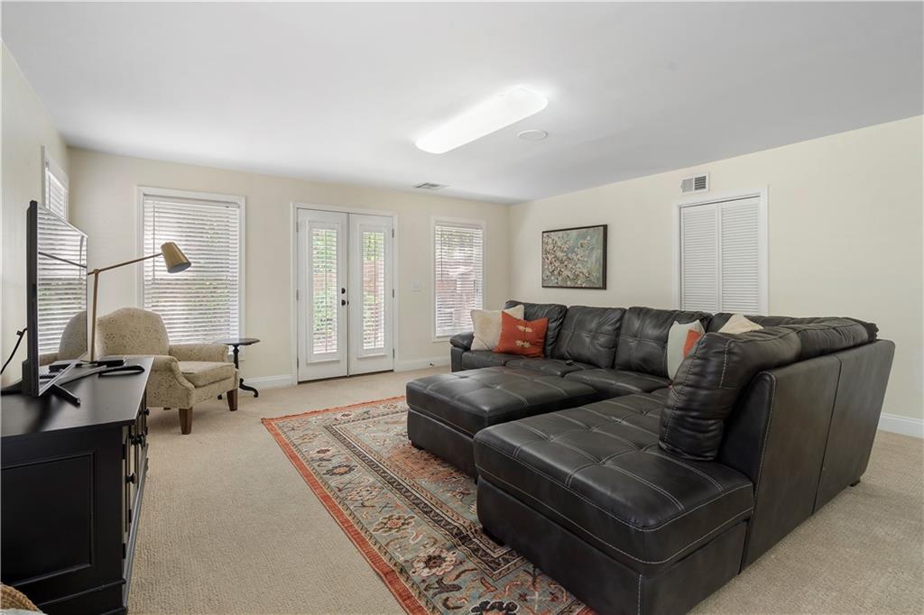 1174 Bowerie Chase Powder Springs, GA 30127 - Photo 52 of 70 a living room with furniture and a flat screen tv