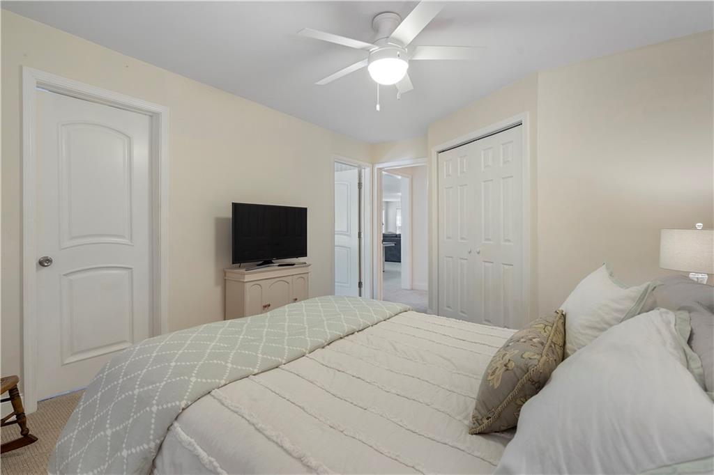 1174 Bowerie Chase Powder Springs, GA 30127 - Photo 55 of 70 a bedroom with a bed and a flat screen tv