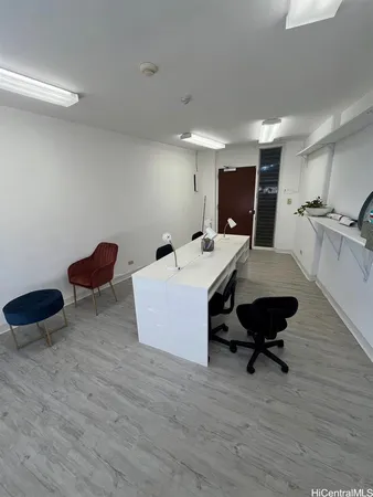 a view of a room with gym equipment and wooden floor
