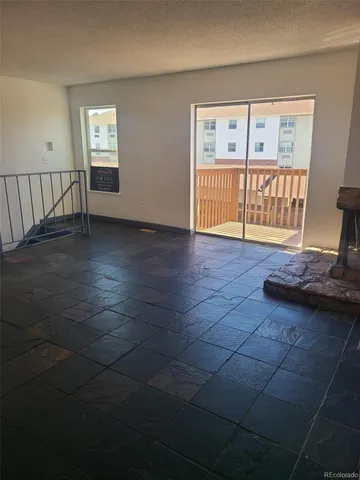 a view of an empty room with a window