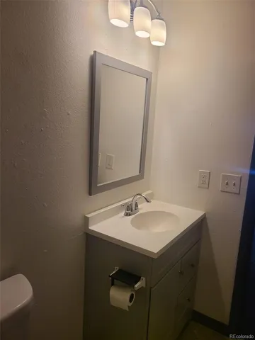 a bathroom with a sink vanity and a mirror