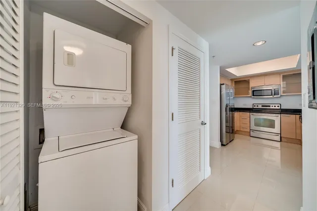 a view of a kitchen with white cabinets and stainless steel appliances