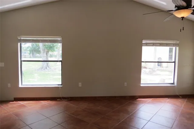 a view of empty room with a fan