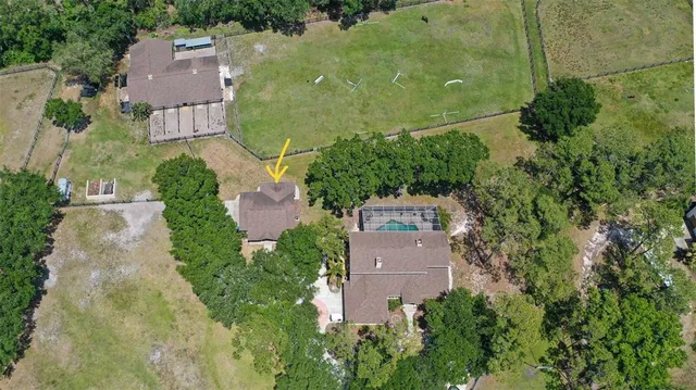 a view of a house with porch and garden