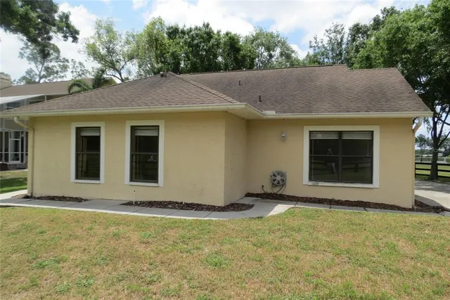 a view of park bench sitting next to a yard
