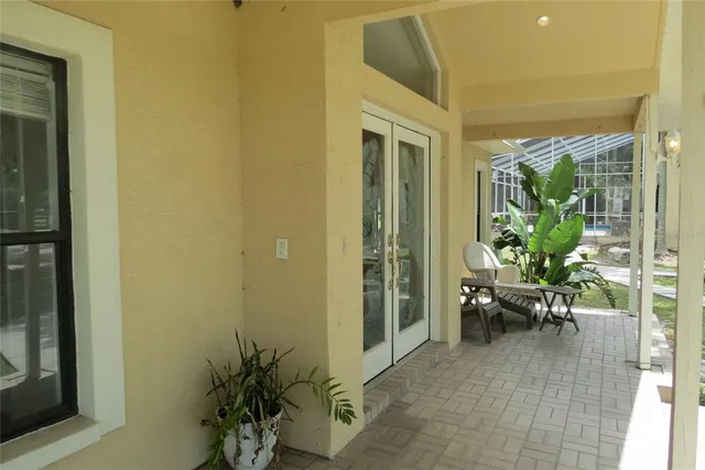 a view of a house with backyard porch and sitting area