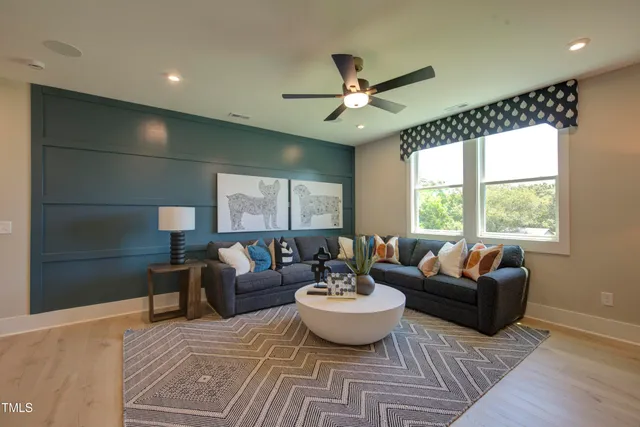 a view of a livingroom with furniture and hardwood floor