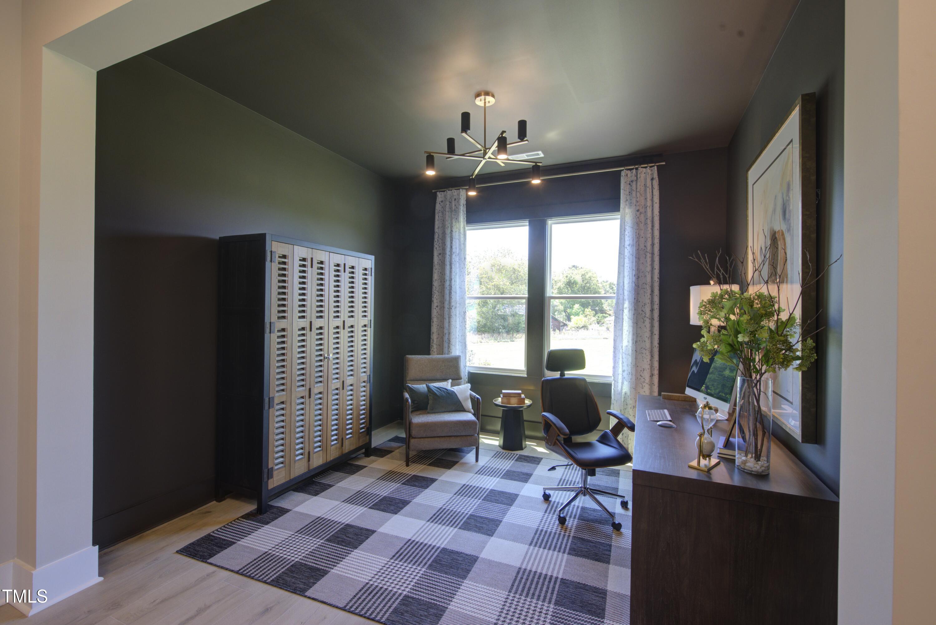306 Golden Leaf Farms Road Angier, NC 27501 - Photo 16 of 21 a living room with furniture and a chandelier