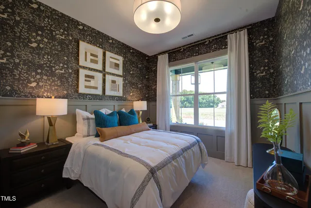 a bedroom with a bed and a chandelier