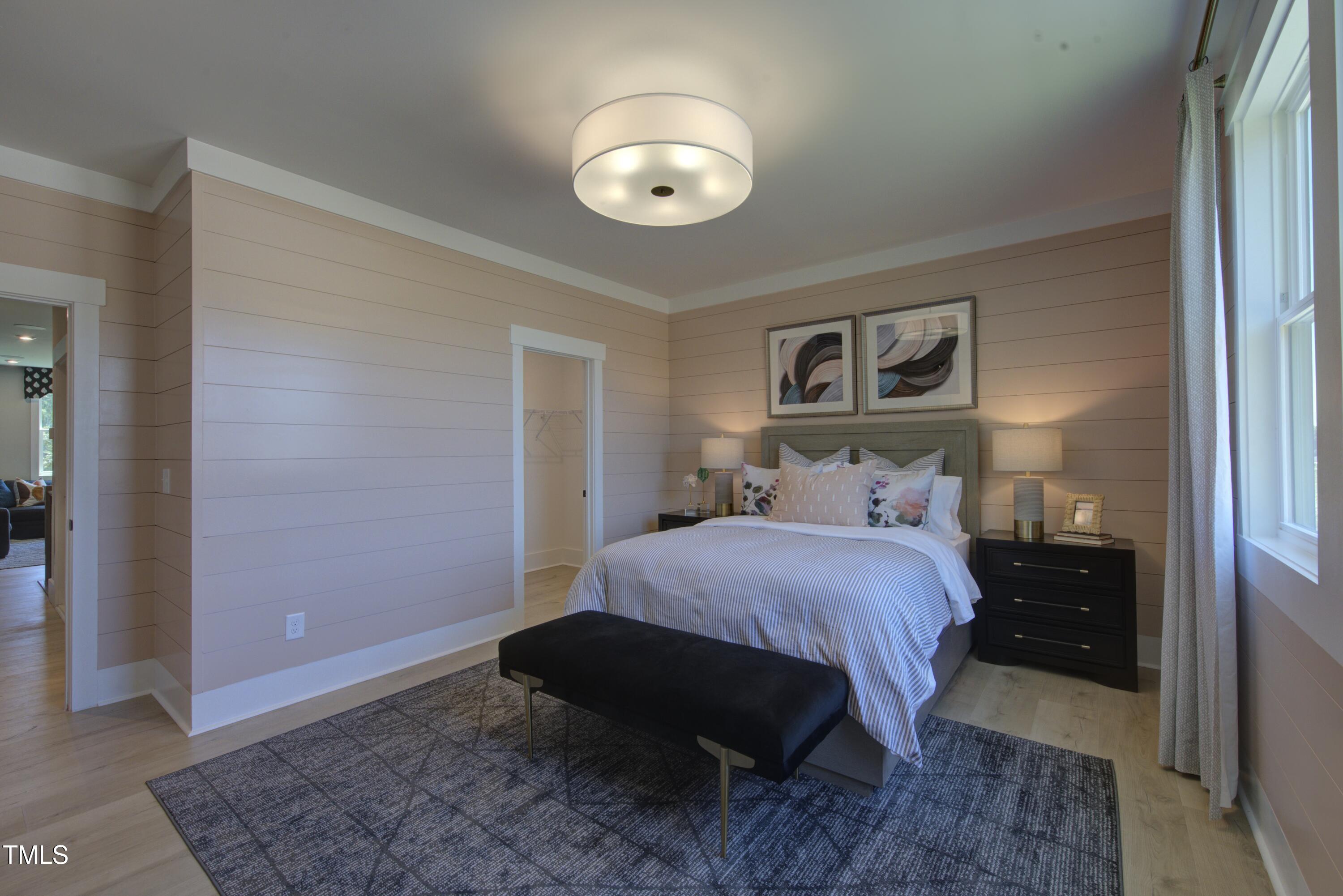 306 Golden Leaf Farms Road Angier, NC 27501 - Photo 21 of 21 a bedroom with a bed and a mirror
