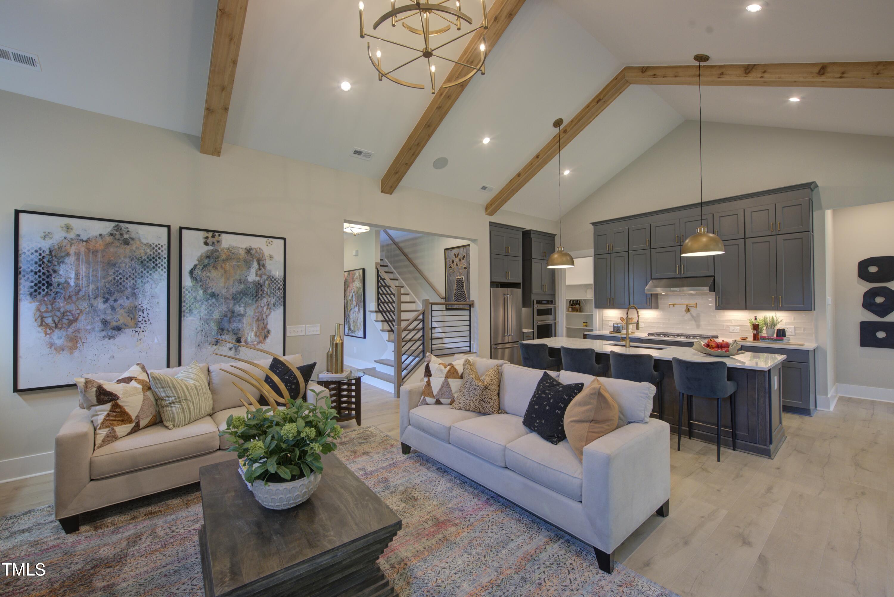 306 Golden Leaf Farms Road Angier, NC 27501 - Photo 3 of 21 a living room with furniture potted plant and kitchen view