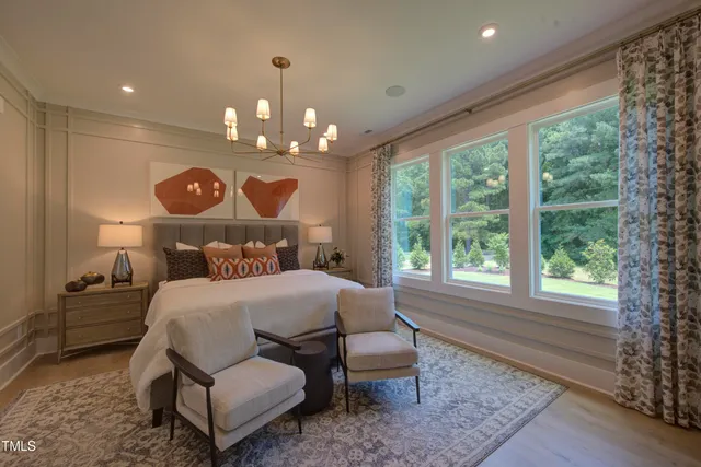 a kitchen with stainless steel appliances a table and chairs in it
