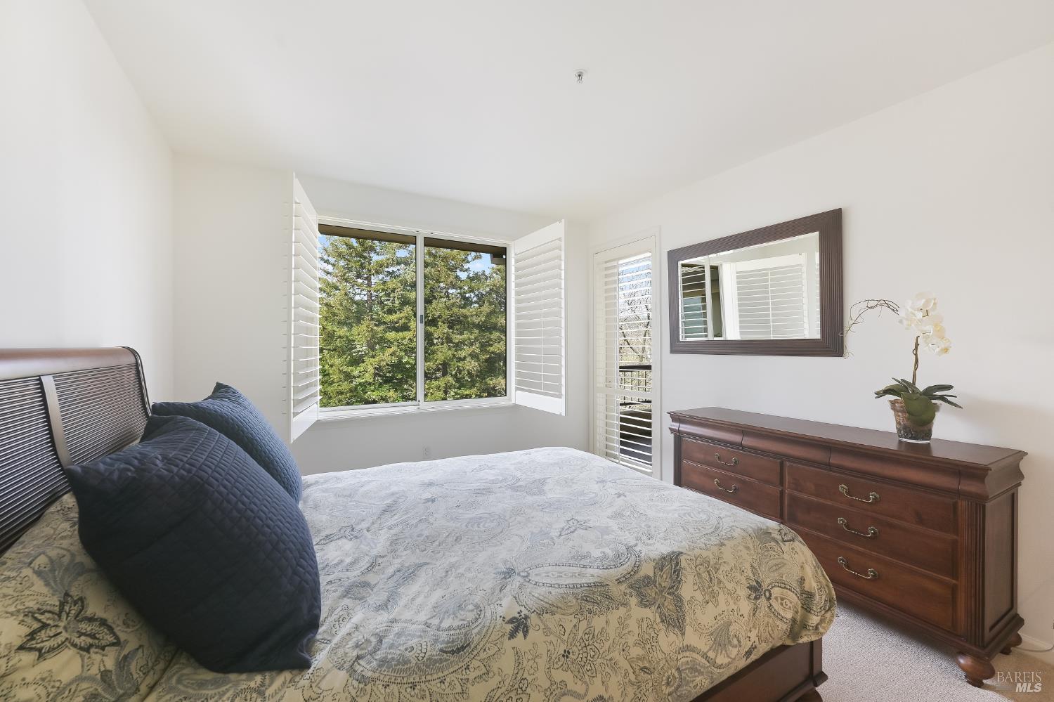 600 Deer Valley Road, Unit 3E San Rafael, CA 94903 - Photo 5 of 18 a bedroom with a bed and a dresser next to a window