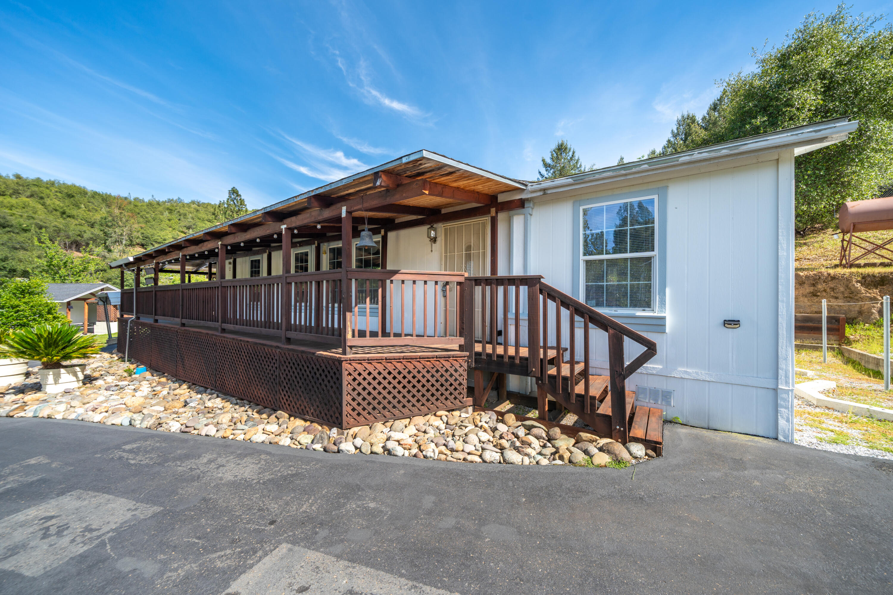 22151 Ravine Court Redding, CA 96003 - Photo 1 of 34 a view of a house with wooden deck front of house