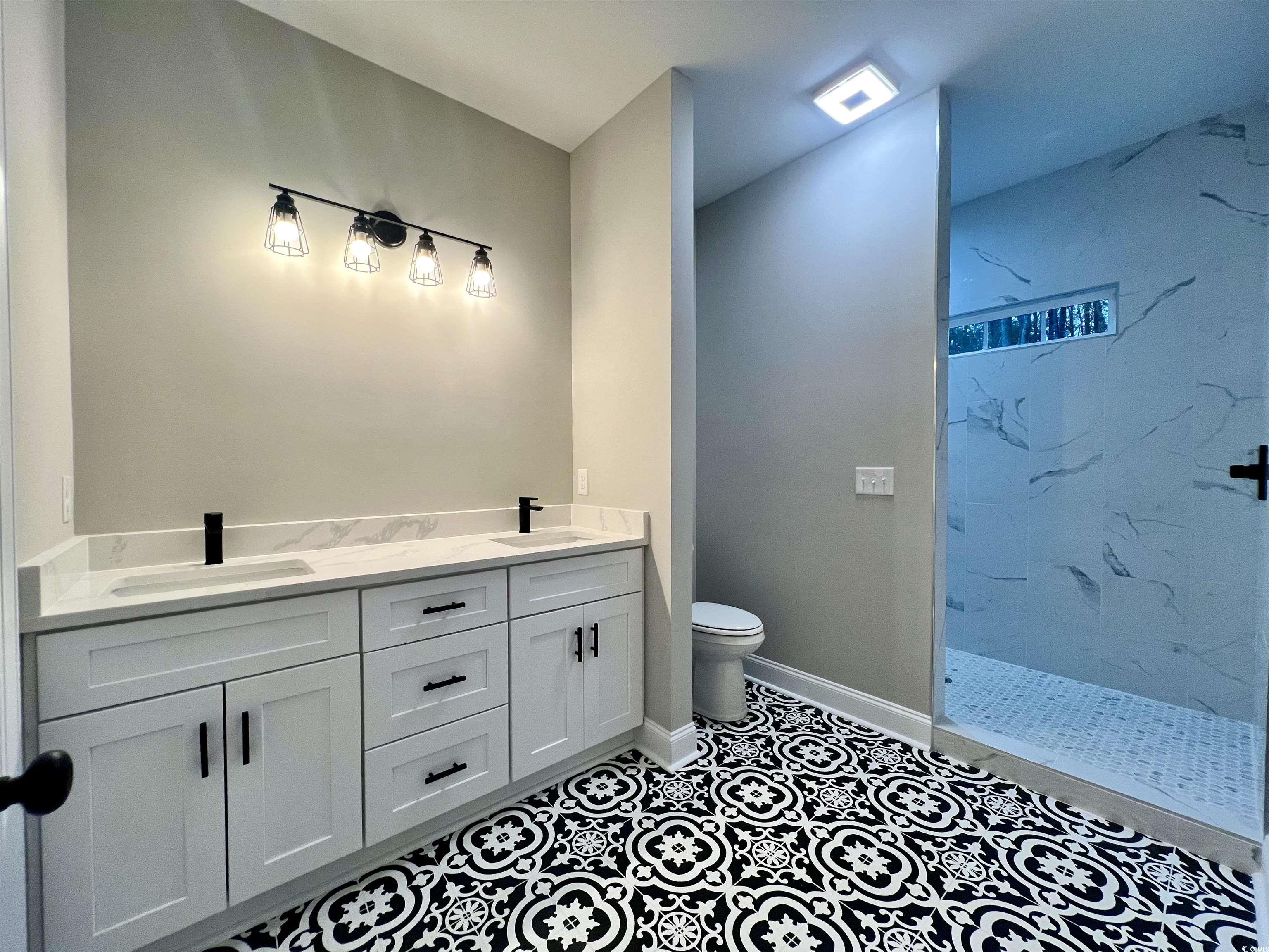 1107 Highway 9 Business Loris, SC 29569 - Photo 25 of 33 Bathroom with tile patterned floors, vanity, toilet, and a tile shower