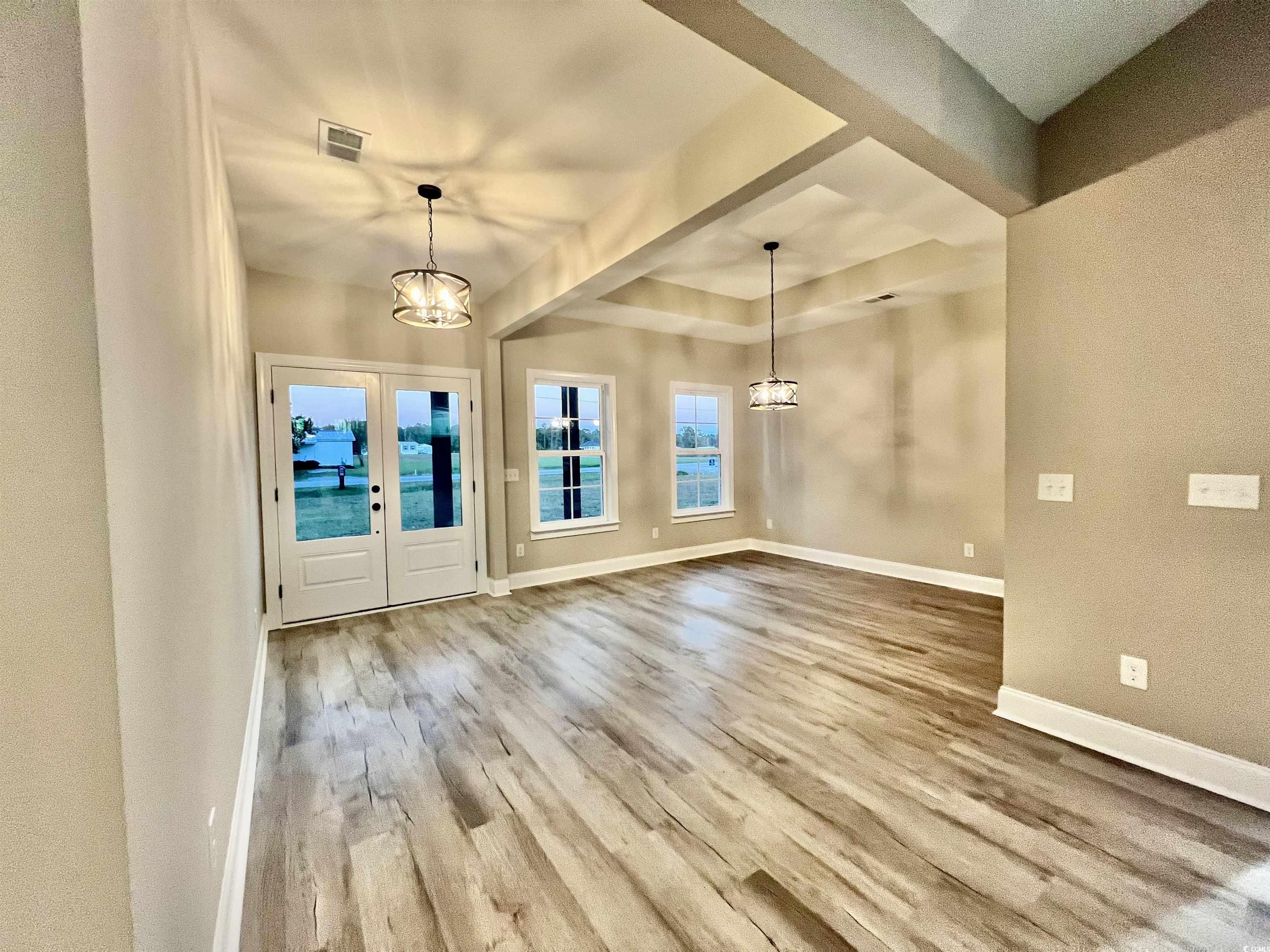 1107 Highway 9 Business Loris, SC 29569 - Photo 31 of 33 Foyer entrance with hardwood / wood-style floors, french doors, and an inviting chandelier