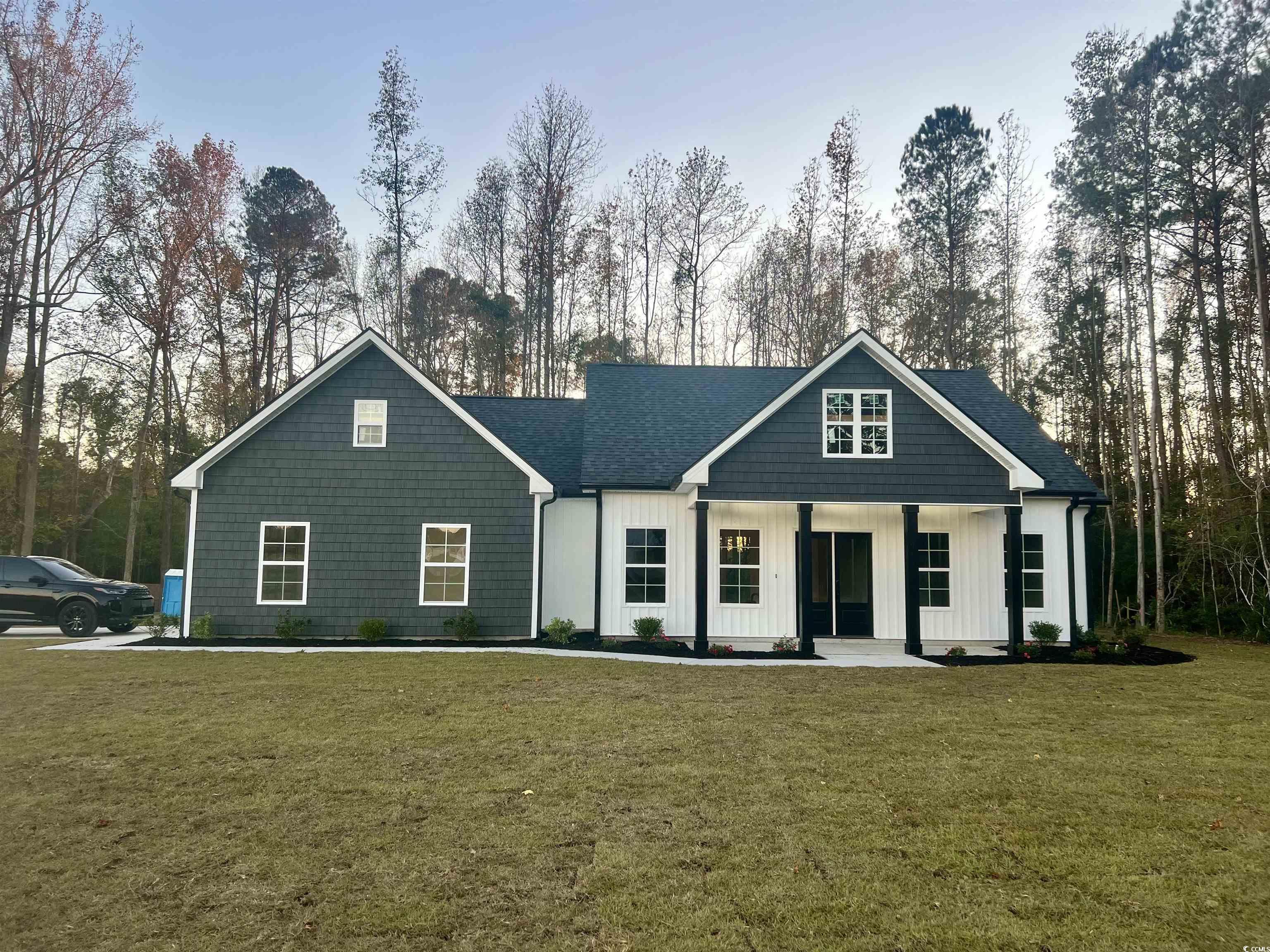 1107 Highway 9 Business Loris, SC 29569 - Photo 33 of 33 View of front of property featuring covered porch and a front yard