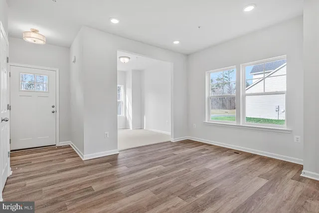 a view of kitchen with wooden floor and electronic appliances