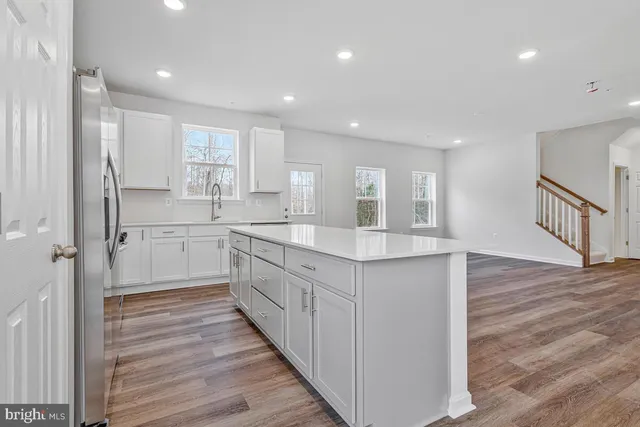 a spacious bathroom with a sink and a mirror