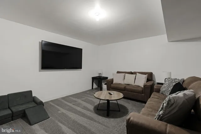 a living room with furniture and a wooden door