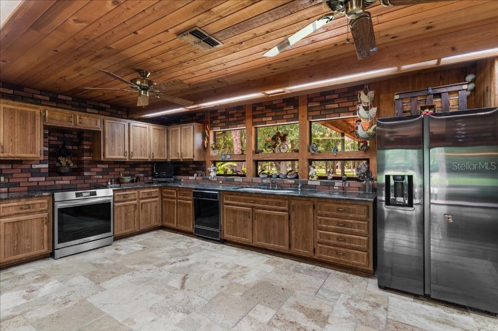 935 Ranch Road Tarpon Springs, FL 34688 - Photo 17 of 40 a kitchen with a sink and stainless steel appliances
