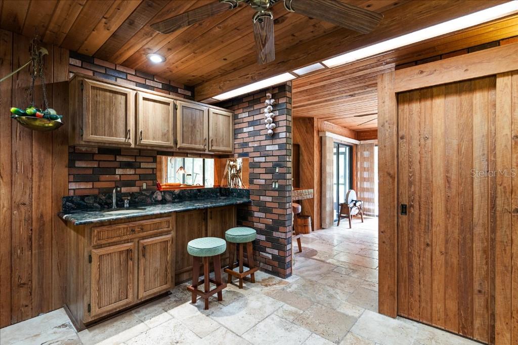 935 Ranch Road Tarpon Springs, FL 34688 - Photo 19 of 40 a view of a chairs and table in a patio