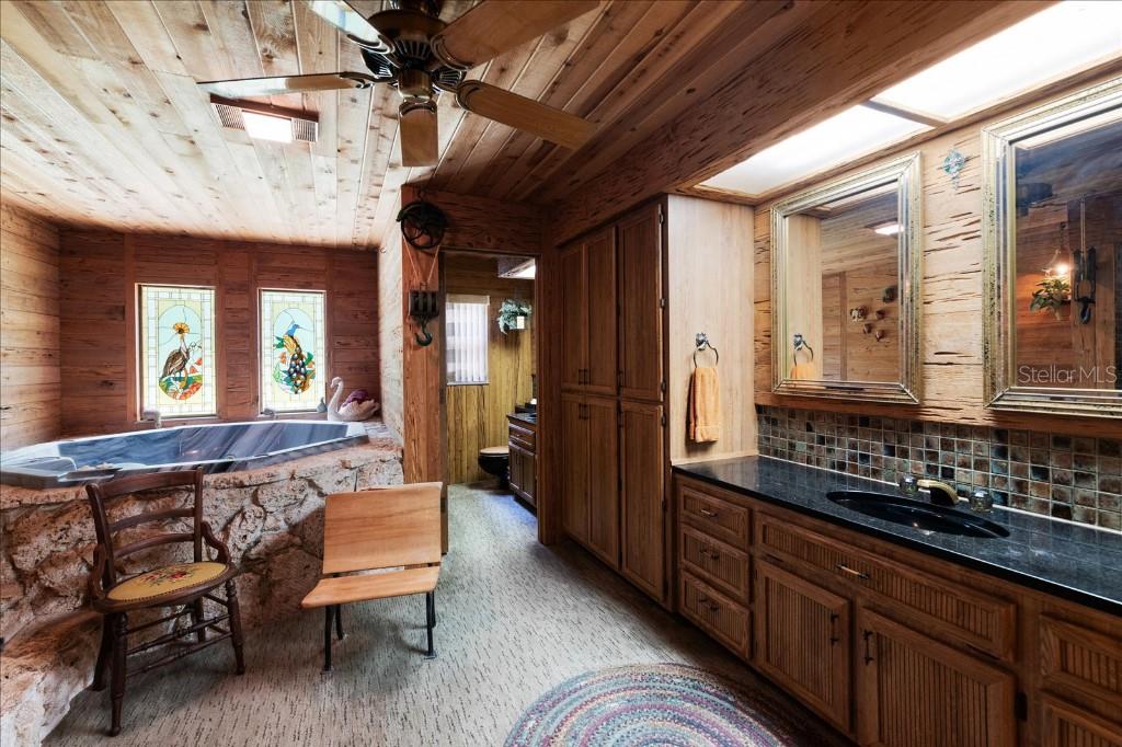 935 Ranch Road Tarpon Springs, FL 34688 - Photo 23 of 40 a spacious bathroom with a double vanity sink and a mirror