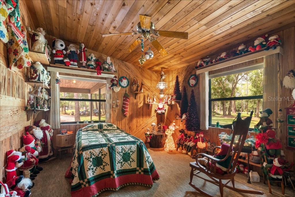 935 Ranch Road Tarpon Springs, FL 34688 - Photo 28 of 40 a bedroom with furniture and a chandelier