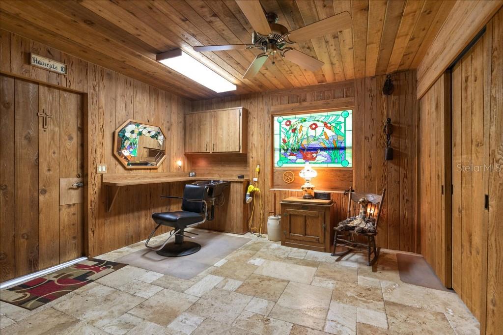 935 Ranch Road Tarpon Springs, FL 34688 - Photo 29 of 40 a view of a workspace with furniture and a window