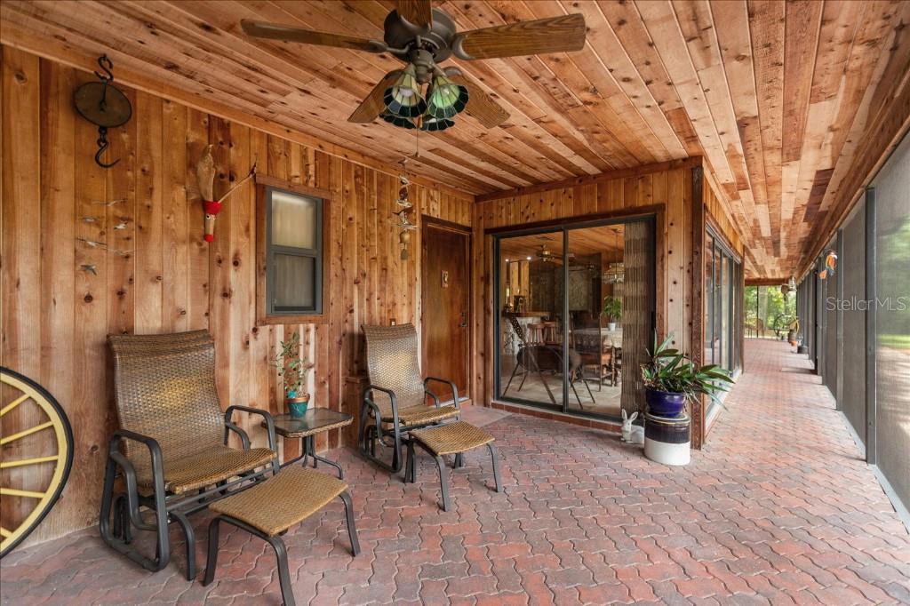 935 Ranch Road Tarpon Springs, FL 34688 - Photo 32 of 40 a view of a patio with table and chairs and potted plants
