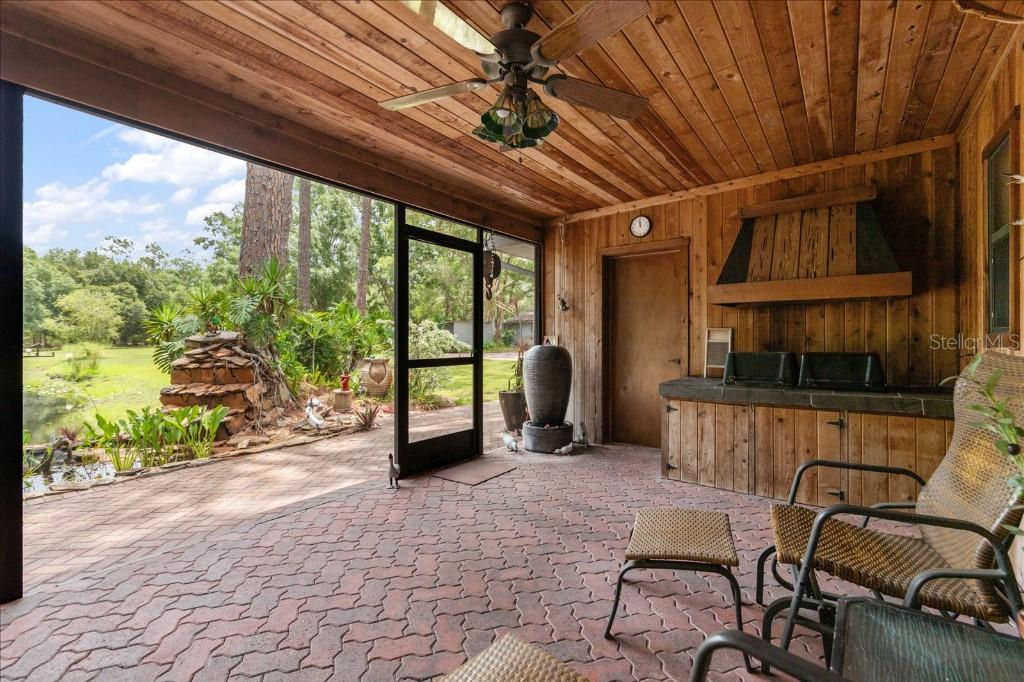 935 Ranch Road Tarpon Springs, FL 34688 - Photo 33 of 40 a view of a porch with furniture and a yard