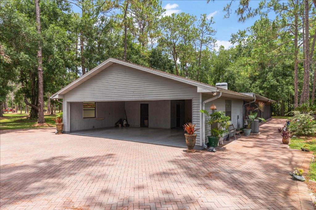 935 Ranch Road Tarpon Springs, FL 34688 - Photo 36 of 40 a wooden house with a large outdoor space