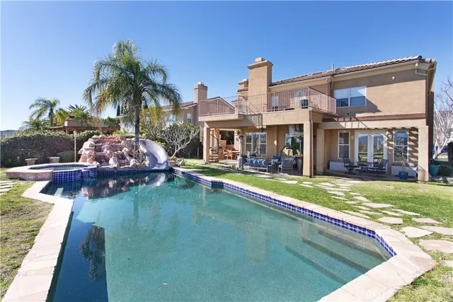 a living room with patio furniture and a flat screen tv