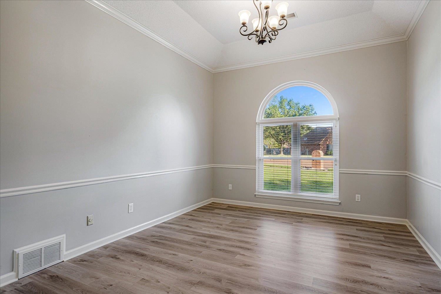 910 Sugar Cove Collierville, TN 38017 - Photo 15 of 32 Spare room featuring a chandelier, crown molding, wood finished floors, and vaulted ceiling