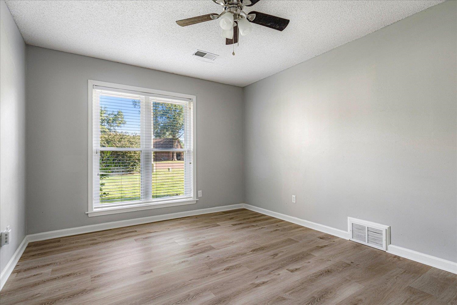 910 Sugar Cove Collierville, TN 38017 - Photo 23 of 32 Empty room with light wood-style flooring, a textured ceiling, and ceiling fan