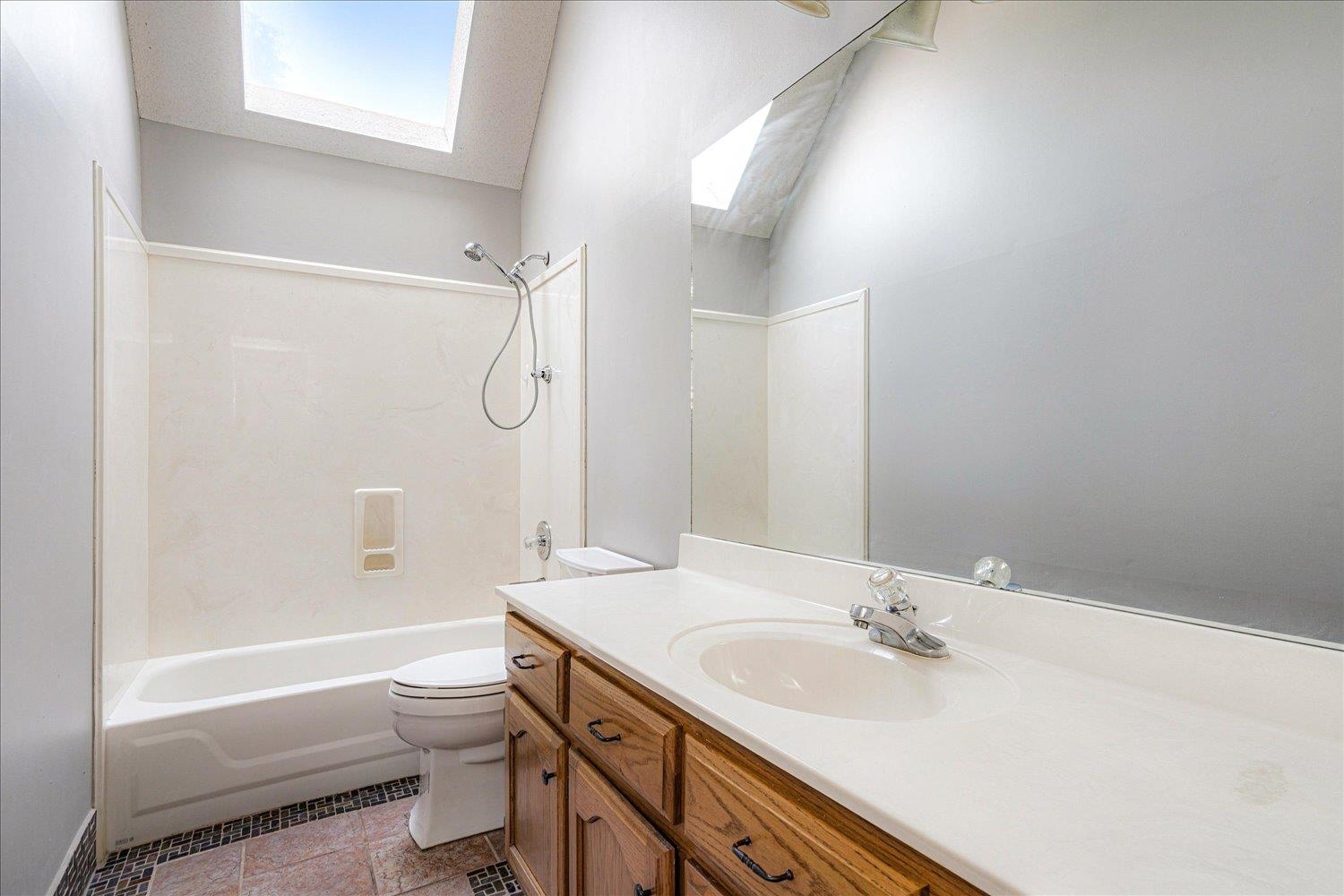 910 Sugar Cove Collierville, TN 38017 - Photo 25 of 32 Full bath featuring a skylight, shower / washtub combination, vanity, and light tile patterned floors