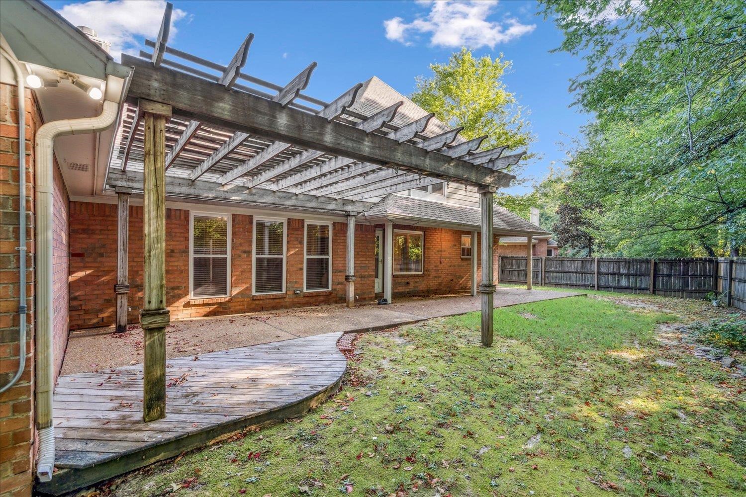 910 Sugar Cove Collierville, TN 38017 - Photo 29 of 32 Back of house featuring a pergola, a patio area, a fenced backyard, brick siding, and a shingled roof