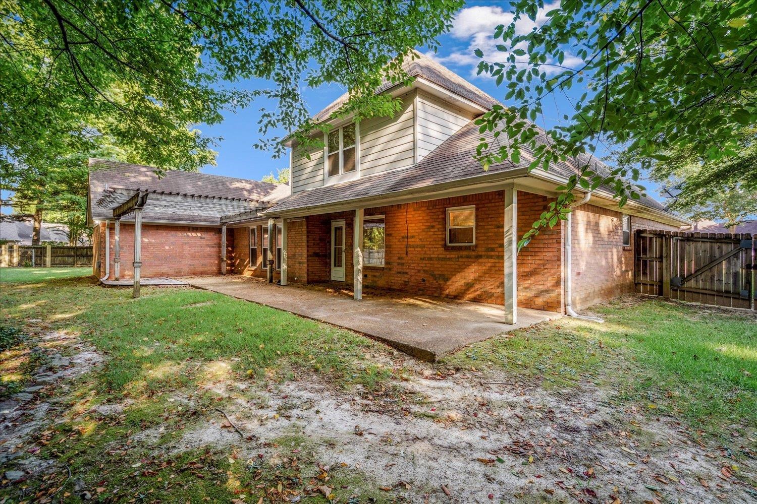 910 Sugar Cove Collierville, TN 38017 - Photo 31 of 32 Back of house featuring a patio area, brick siding, and a shingled roof