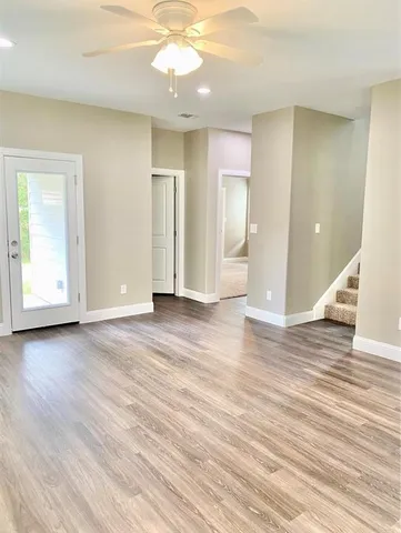 wooden floor in an empty room with a window
