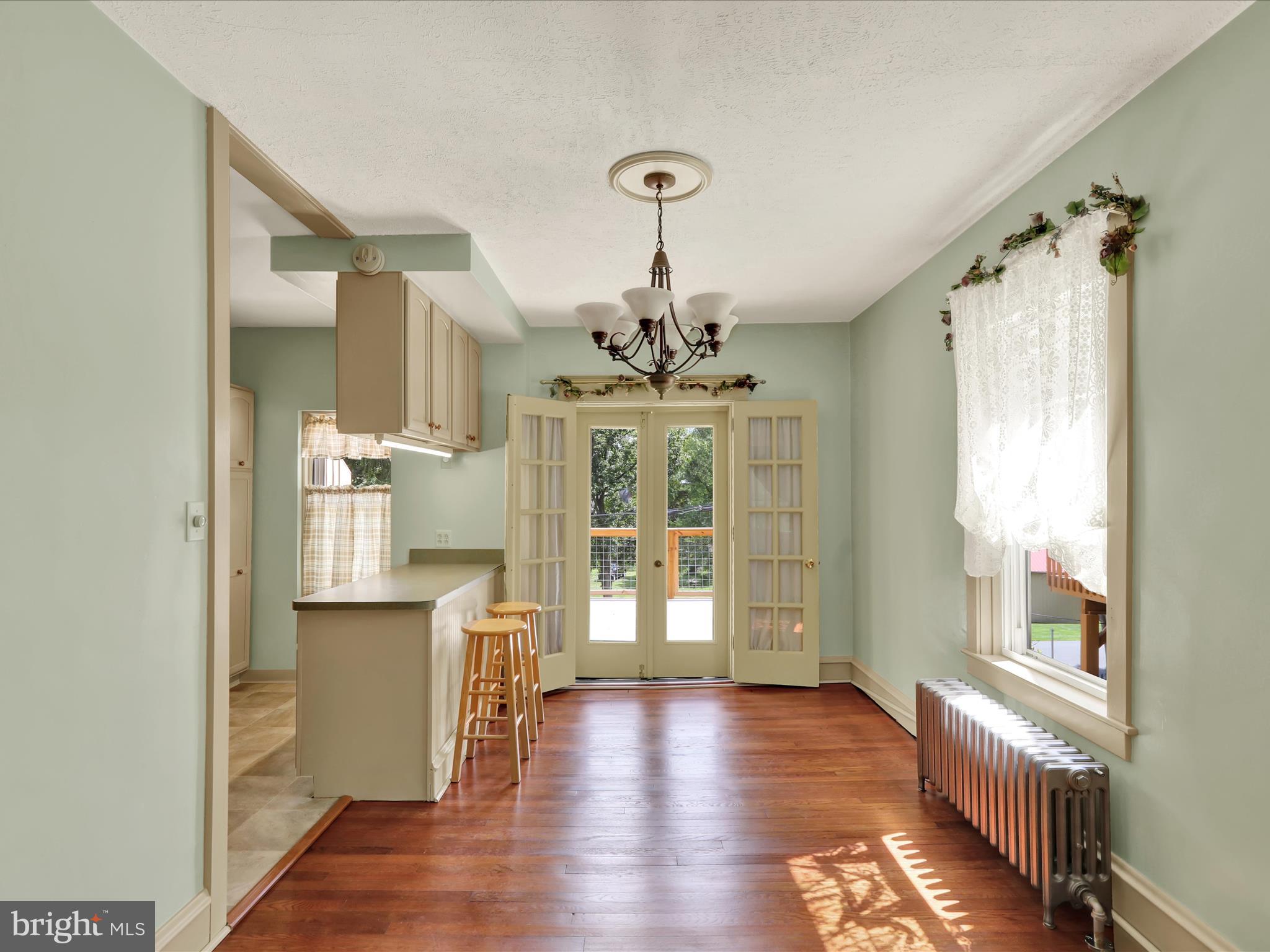 519 Friedensburg Road Reading, PA 19606 - Photo 10 of 47 a view of a hallway with wooden floor and a kitchen