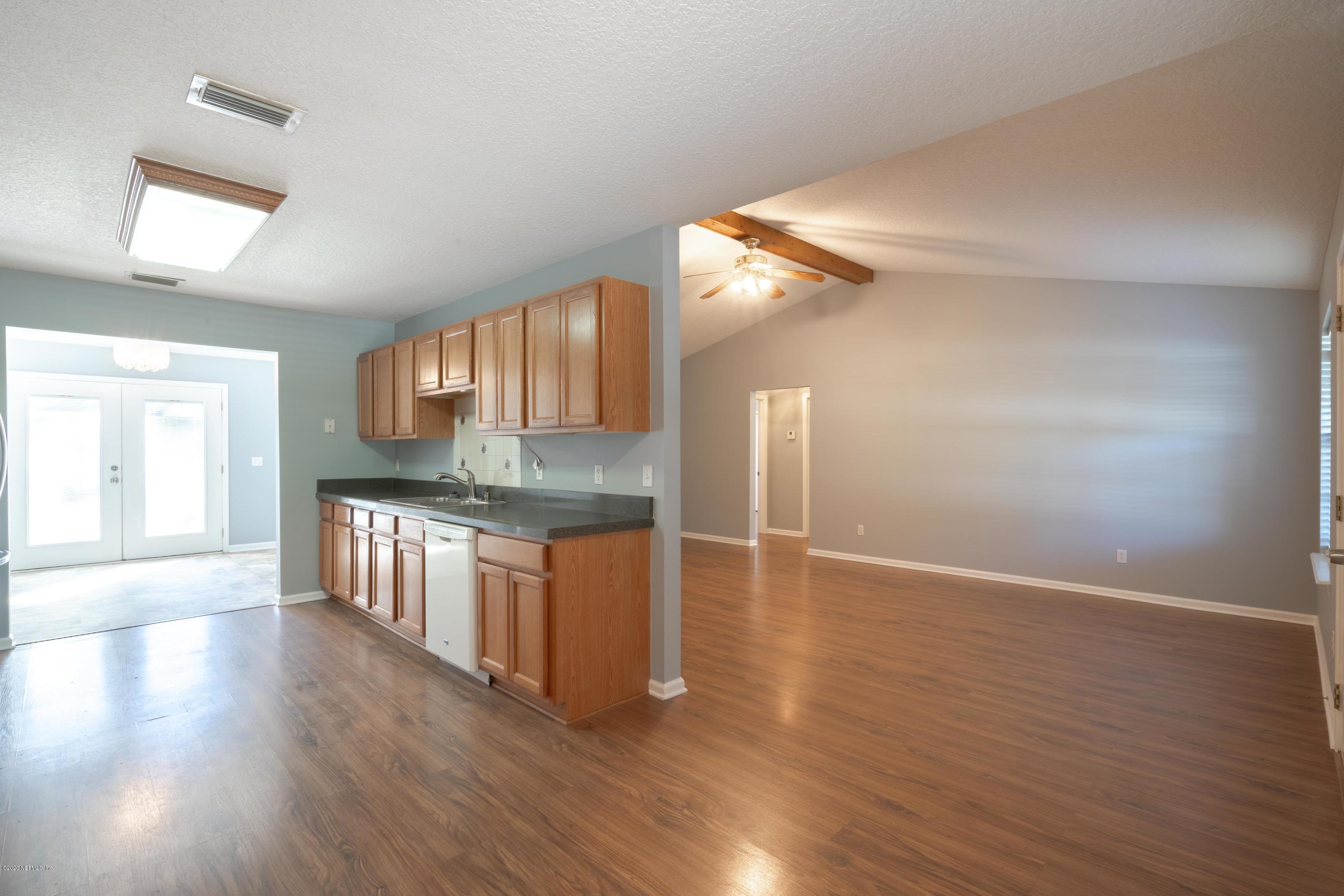 1175 Cahoon Road South Jacksonville, FL 32221 - Photo 3 of 16 a view of kitchen with granite countertop cabinets and wooden floor
