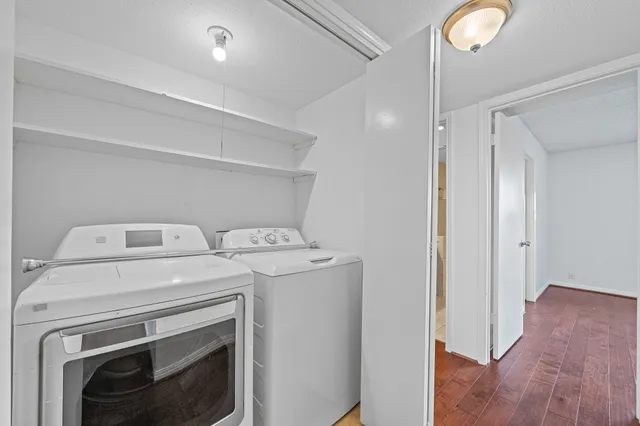 a view of washer and dryer with wooden floor