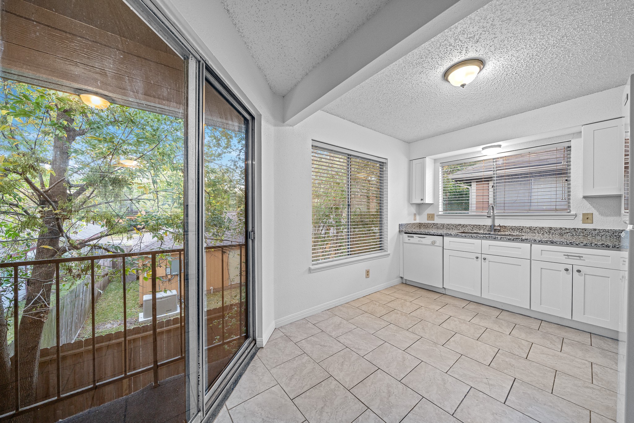 12100 Overbrook Lane, Unit 17D Houston, TX 77077 - Photo 18 of 22 a large white room with a large window and kitchen view