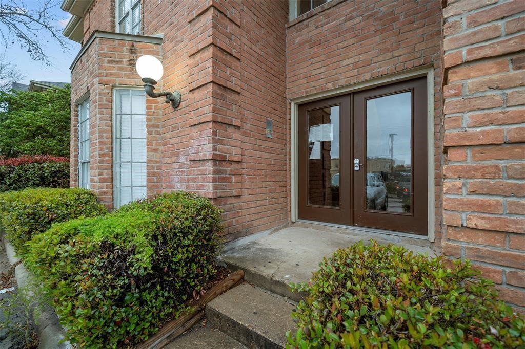 12100 Overbrook Lane, Unit 17D Houston, TX 77077 - Photo 3 of 22 a front view of a house with a yard