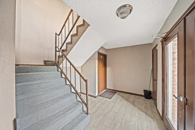 a view of entryway and hall with wooden floor